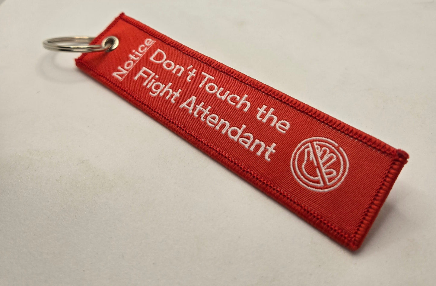 "DON'T TOUCH THE FLIGHT ATTENDANT" bag tag